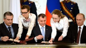 El presidente ruso, Vladímir Putin, a la derecha de la imagen, firma la anexión de Crimea con representantes de la península, el 18 de marzo de 2014 en Moscú. KIRILL KUDRYAVTSEV (AFP)